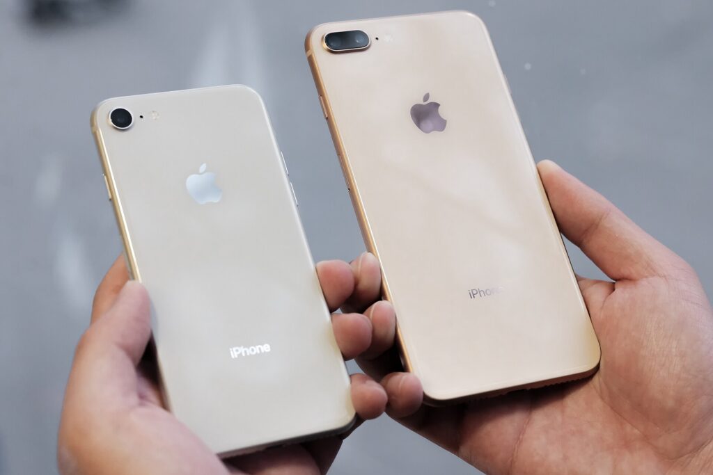 Silver iPhone 8 and gold iPhone 8 Plus held side by side
