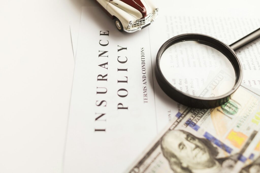 Insurance policy document with a magnifying glass resting on it